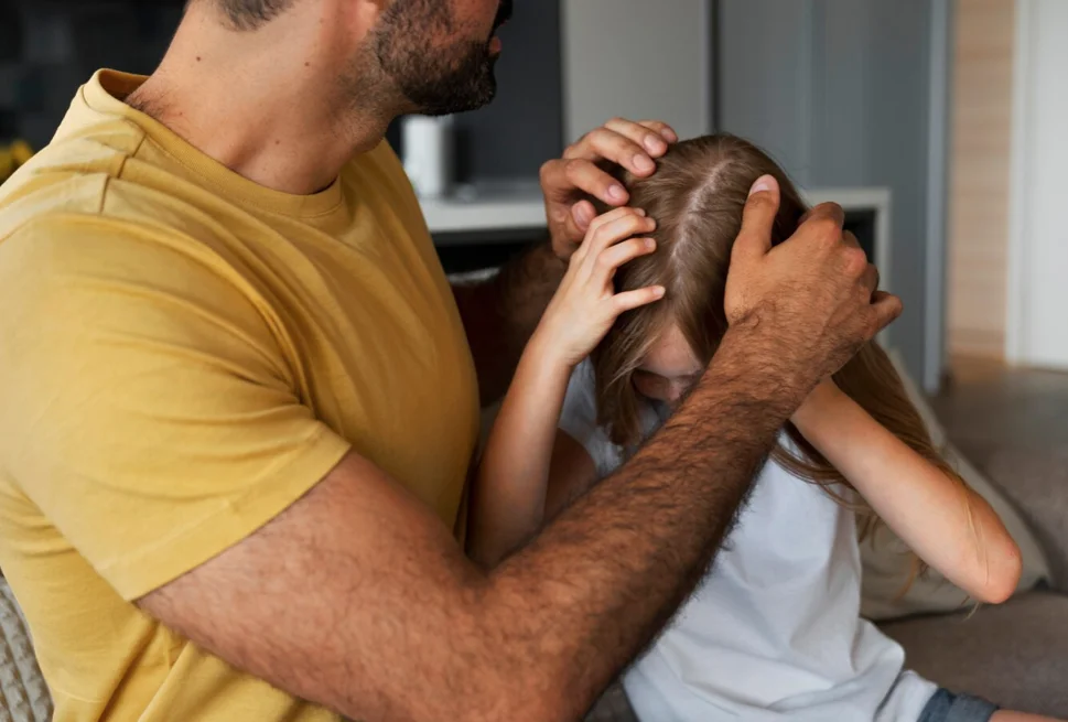 dad and girl scratching head lice sisters lice treatment